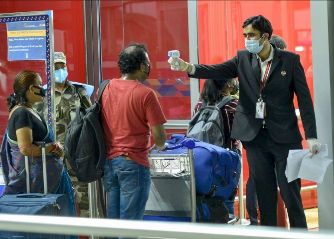 A passenger gets thermal scanned as he arrives at T-3 airport for domestic travel, after flights were resumed, in New Delhi, Monday, May 25, 2020. Passenger flight operations were stopped in March after a nationwide lockdown was ordered to halt the spread of the COVID-19. (PTI Photo/Kamal Kishore)